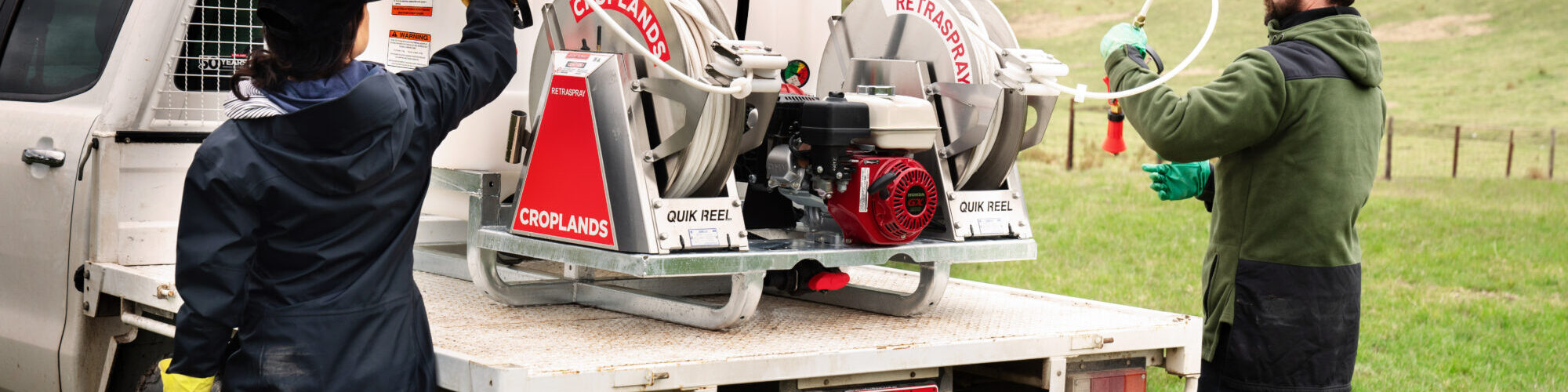 Croplands RetraSpray Twin - new reel Croplands TrayPak sprayer with Retraspray reel on the back of a ute with two people