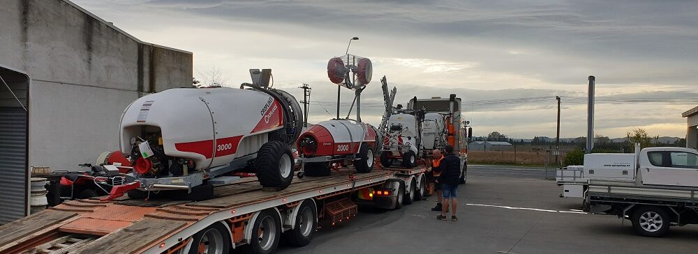 Truck and trailer loaded with Croplands sprayers leave the workshop